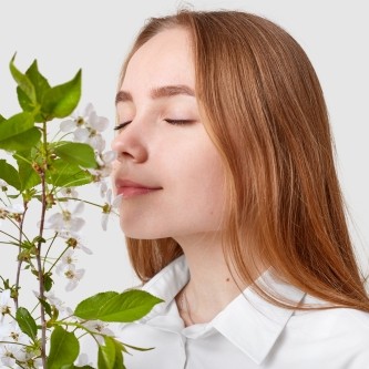 pleased-attractive-woman-smells-cherry-blossom-0505-2023-0734050-wWw_500x500x1